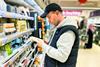 man looking at cheese in supermarket shopper sainsburys GettyImages-1429988567